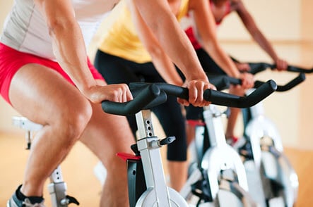 men exercise on bicycle